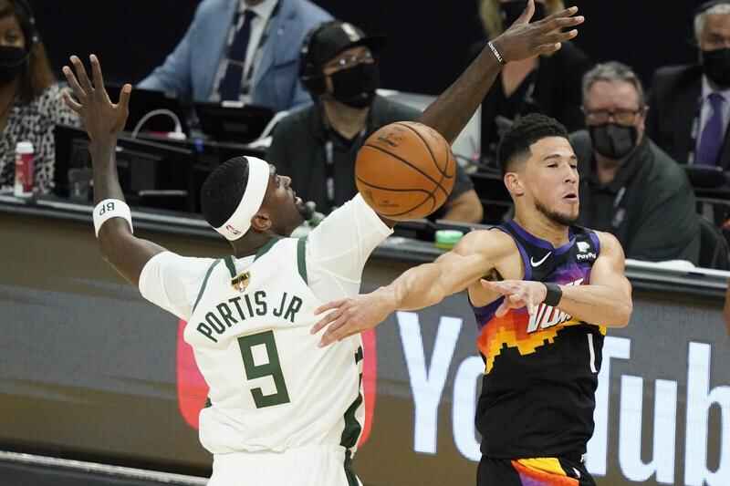 Milwaukee Bucks' guards playing defense on Suns' Paul and Booker