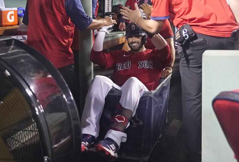 J.D. Martinez of the Boston Red Sox is pushed in a laundry cart