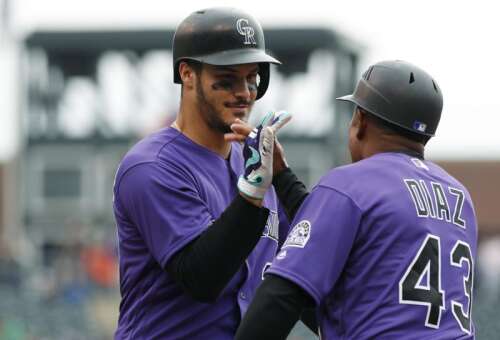 Jonathan Lucroy is congratulated by Mark Reynolds