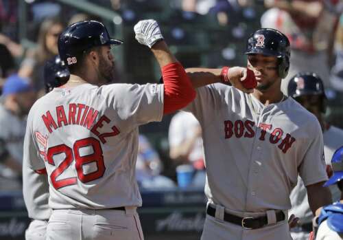 Seattle Mariners' Omar Narvaez (22) is greeted by manager Scott