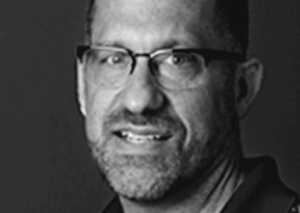 Headshot photo of columnist Dr. Jon Gaudio