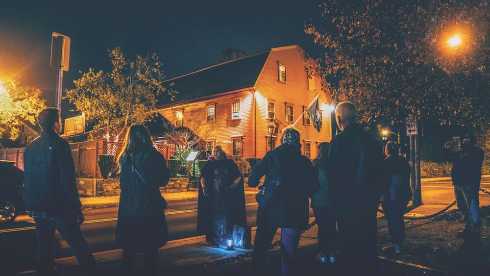 Ghost Tours of Newport’s guide stands in front of the oldest tavern building in the country, The White Horse, where a murdered traveler’s spirit still waits for revenge on the second floor of the 300-plus-year-old landmark. (Photo courtesy of Discover Newport)
